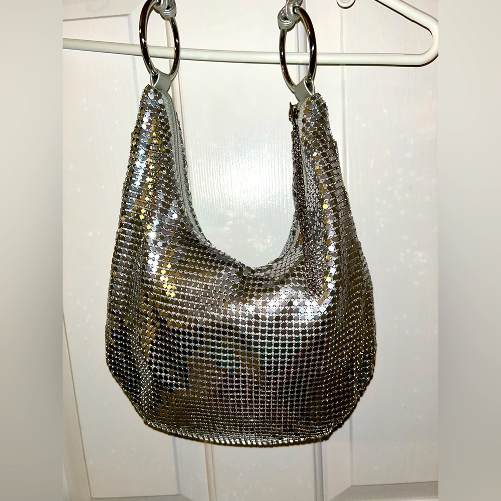 Silver Metallic Mesh Shoulder Bag with Leather handle. Zippered top.